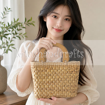 Handwoven water hyacinth handbag with wooden top handle style.