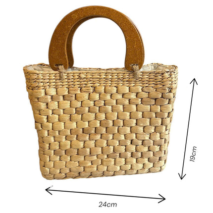 Handwoven water hyacinth handbag with wooden top handle available in multiple sizes.