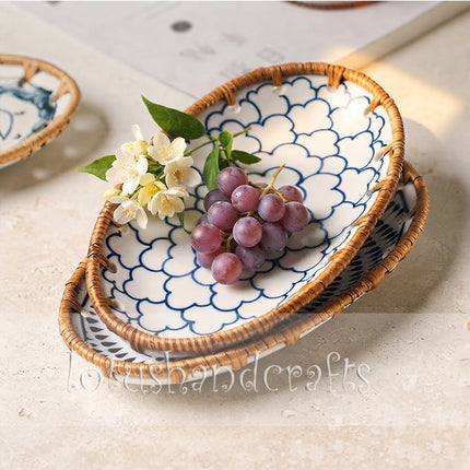 Oval ceramic tray featuring a graceful radiating blossom design with handcrafted rattan edging.