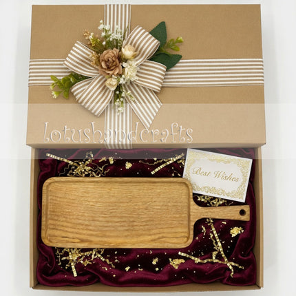 Long ash wood serving board with handle makes a thoughtful and practical gift.