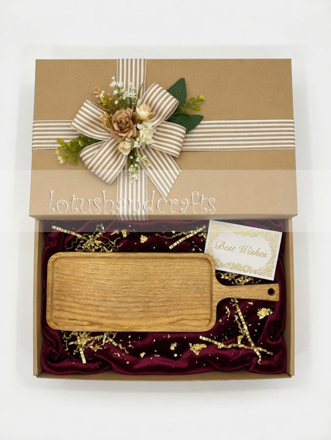 Long ash wood serving board with handle makes a thoughtful and practical gift.
