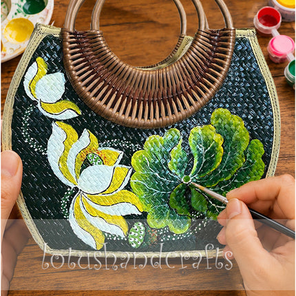 Handwoven rattan bag with hand painted lotus blossom and seashell details.