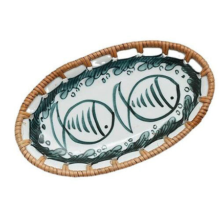 Handmade oval ceramic tray featuring a charming twin teal fish pattern framed by a natural woven rattan edge.