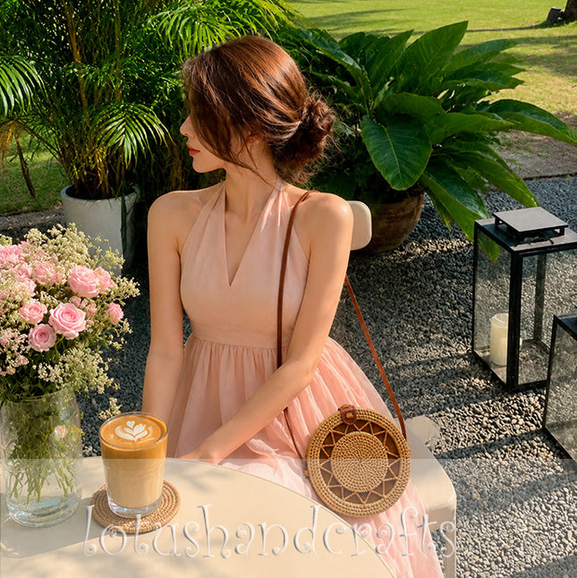 An elegant handwoven round rattan crossbody bag for everyday boho style.