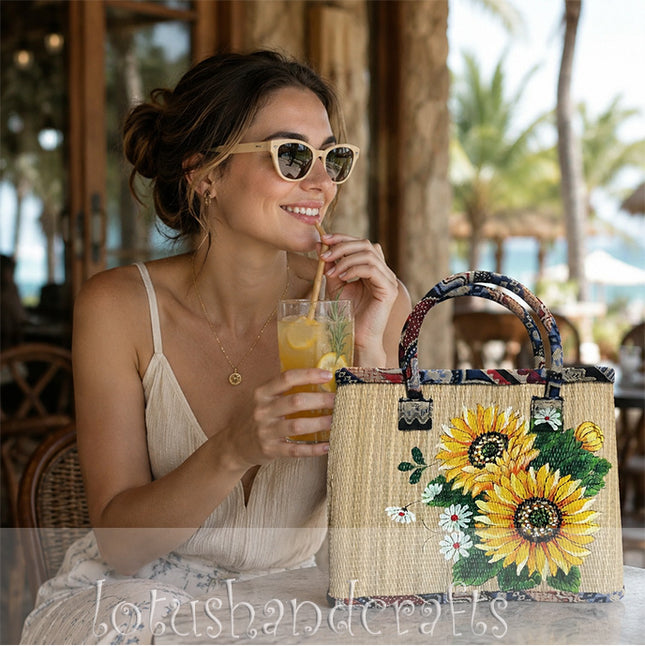 Handwoven seagrass tote bag with vibrant hand painted sunflowers and a youthful style.