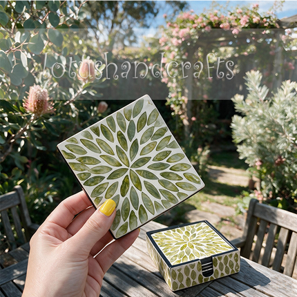 artisan cut shell tiles forming seamless green leaf pattern coaster and holder.