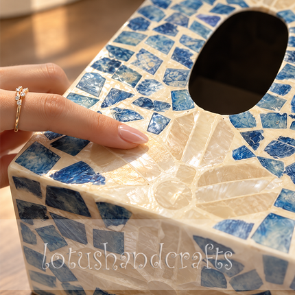 Close-up view of the handcrafted blue lily motif on a luminous mother-of-pearl mosaic tissue box.