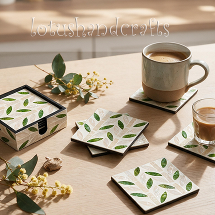Detailed view of green leaf foliage pattern on handmade mother-of-pearl square coaster set.