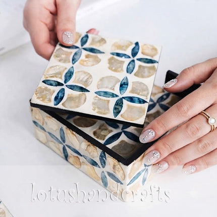 light reflecting on mother of pearl coasters, clover design glowing beautifully.