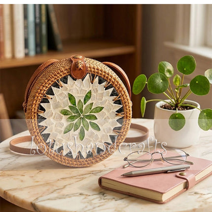 This youthful round rattan crossbody bag with mother of pearl leaf mosaic and leather strap stands out.