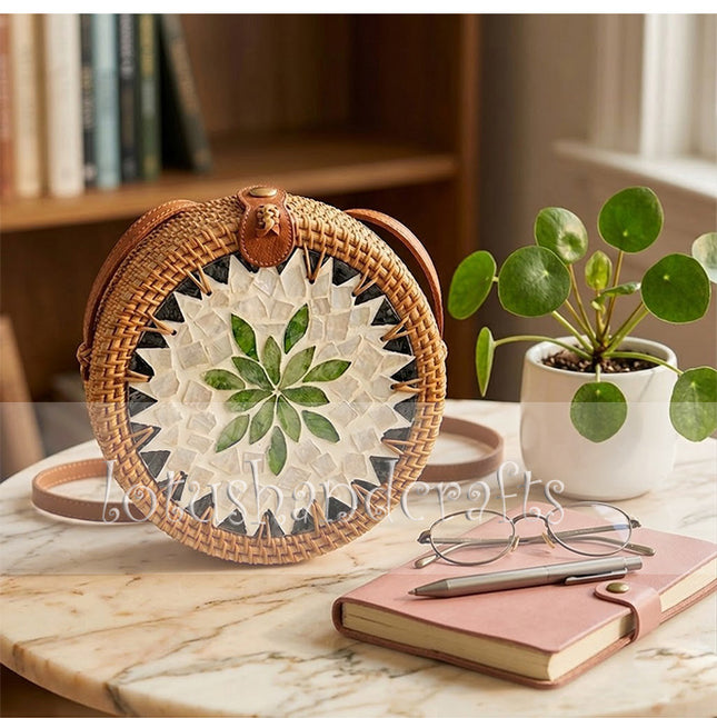 This youthful round rattan crossbody bag with mother of pearl leaf mosaic and leather strap stands out.