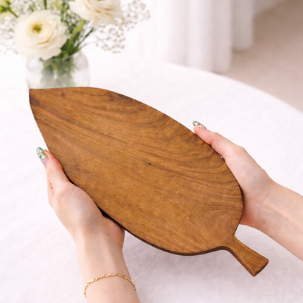 Handcrafted leafcraft wooden serving board made from redwood offers natural beauty and durability.