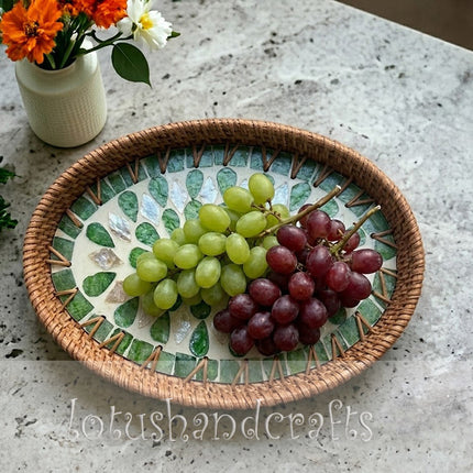 This captivating handwoven oval rattan tray features an intricate green leaf mother of pearl mosaic inlay.