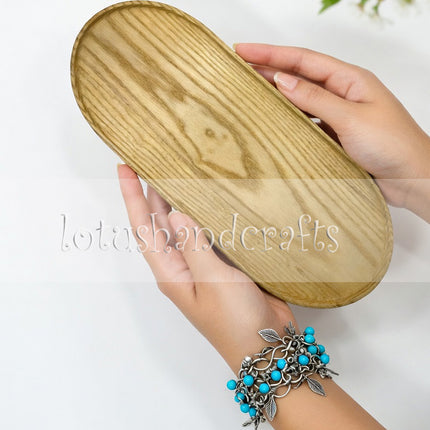 Handcarved haven oval ashwood serving tray with durable craftsmanship and timeless natural wooden beauty.