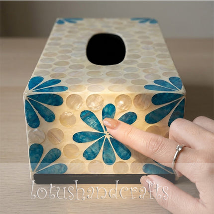 Detailed shot of the shimmering turquoise blue floral motifs catching the light.