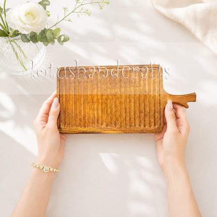 Rectangular wavy redwood serving tray with handles for stylish and versatile everyday dining.