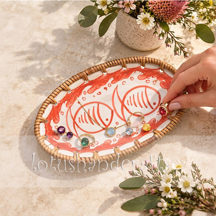 A balanced pair of red fish stands beautifully against the clean white ceramic background.