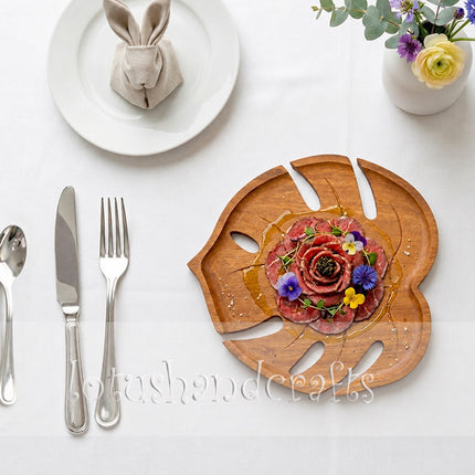 Redwood Monstera shaped serving tray made from natural wood and safe for everyday use.