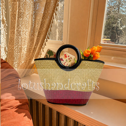 Handwoven seagrass tote bag with round black handle in crimson red by Lotushandcrafts.