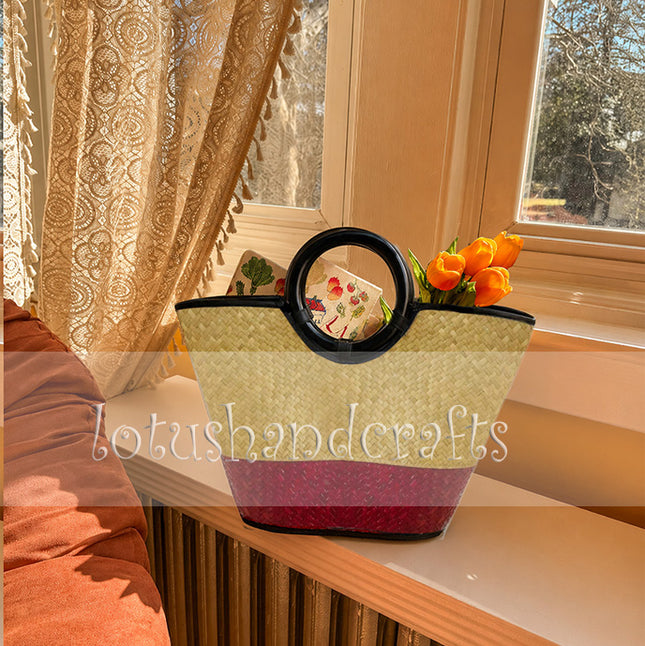 Handwoven seagrass tote bag with round black handle in crimson red by Lotushandcrafts.
