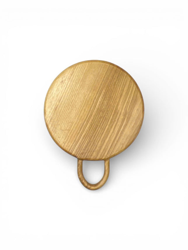 Cute round wood cutting board with a loop handle for easy serving and display.