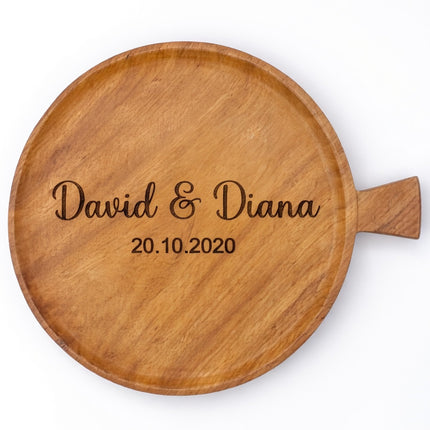 Handcrafted round serving plate with handle and custom engraving service.
