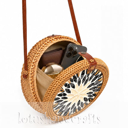 Round woven rattan wicker straw crossbody purse with mother of pearl accents and versatile design.
