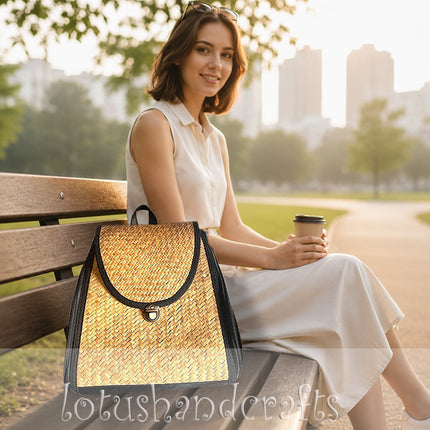 Handwoven seagrass backpack featuring side zipper pockets.