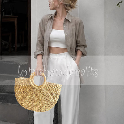 Handwoven half moon seagrass tote bag with round handles for an attractive look.
