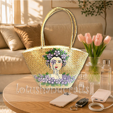 Handwoven seagrass tote bag featuring stylish hand painted floral lady artwork.