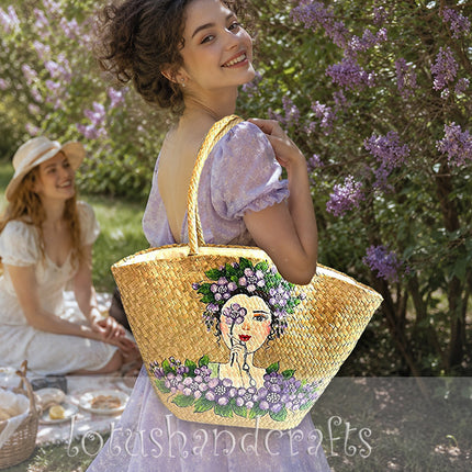 Handwoven seagrass tote bag with elegant hand painted floral lady artwork.