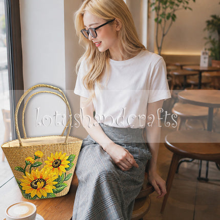 Cute handwoven seagrass tote bag with hand-painted sunflower artwork.