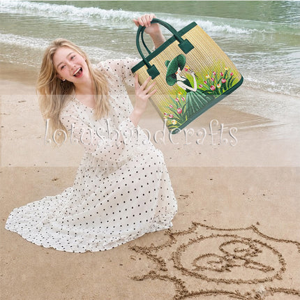 Handwoven seagrass tote bag featuring elegant green lady artwork.