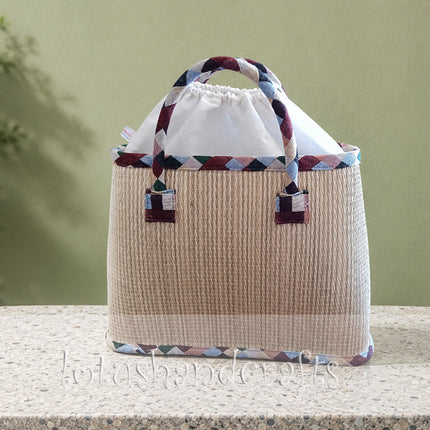 Handmade seagrass tote bag with elegant lotus painting.