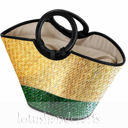 Handwoven seagrass tote bag with a round black handle in natural and forest green.