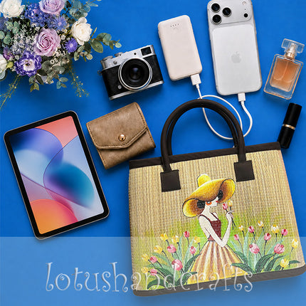 Handwoven seagrass tote bag with a hand-painted girl in a tulip garden, youthful and elegant.