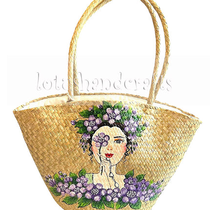 Handwoven seagrass tote bag with hand-painted floral lady artwork.
