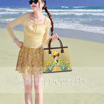 Handwoven seagrass tote bag with a hand-painted girl in a tulip garden.
