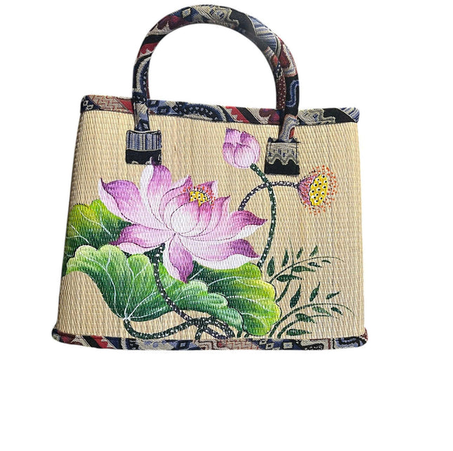 Handmade woven seagrass tote bag with hand-painted lotus blossom.