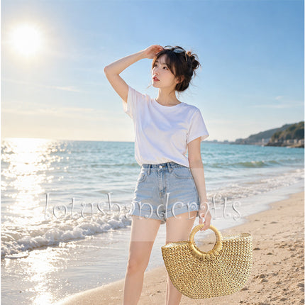 Handwoven half moon seagrass tote bag with round handles that stands out.