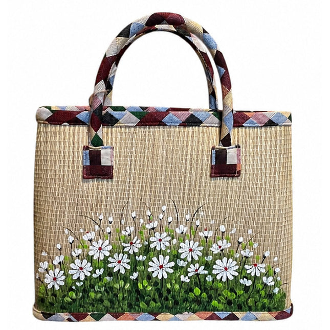 Handwoven seagrass tote bag with a cute hand-painted white wildflower meadow.