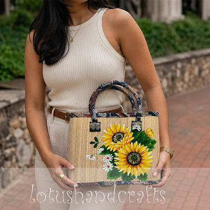 Handwoven seagrass tote bag with vibrant sunflower painting.