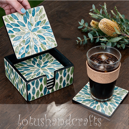 Close-up of botanical shell mosaic coaster holder — iridescent sky blue, turquoise and fresh green leaf pattern.