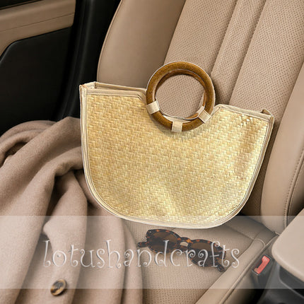 Handwoven straw tote for women with wooden ring handles.