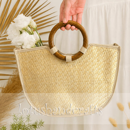 Handmade handwoven straw tote bag with wooden ring handles.