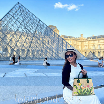 Handwoven seagrass tote bag featuring hand painted tulip artwork.