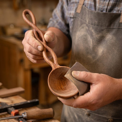 A twisted long handle wooden spoon crafted by skilled artisans with care and precision.