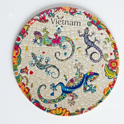 A round ceramic coaster featuring four colourful salamanders with intricate patterns and vibrant hues. 