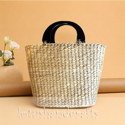 Handwoven water hyacinth straw top handle handbag.