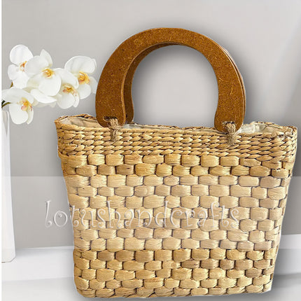 Handwoven water hyacinth handbag with a stylish wooden top handle.